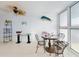 Charming dining space with metal chairs, tile flooring, and large windows at 5201 S Atlantic Ave # 407A, New Smyrna Beach, FL 32169
