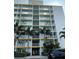 Exterior view of the building with balconies and lush landscaping at 5201 S Atlantic Ave # 407A, New Smyrna Beach, FL 32169