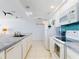 Well-lit kitchen features white appliances, a tile backsplash, and tile countertops at 5201 S Atlantic Ave # 407A, New Smyrna Beach, FL 32169