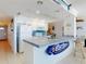Bright and airy kitchen with bar seating and pristine white cabinetry and appliances at 5201 S Atlantic Ave # 407A, New Smyrna Beach, FL 32169
