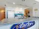Bright kitchen features white cabinets, modern appliances, and a unique blue tile backsplash at 5201 S Atlantic Ave # 407A, New Smyrna Beach, FL 32169