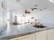 Bright kitchen featuring tiled countertops, white cabinetry, and an open view to the living room at 5201 S Atlantic Ave # 407A, New Smyrna Beach, FL 32169