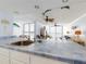Bright kitchen featuring tiled countertops, white cabinetry, and an open view to the living room at 5201 S Atlantic Ave # 407A, New Smyrna Beach, FL 32169