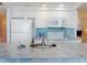 Well-equipped kitchen with white appliances, mosaic backsplash, and tiled countertop with sink at 5201 S Atlantic Ave # 407A, New Smyrna Beach, FL 32169