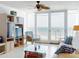 An open living room featuring tile floors, a ceiling fan, comfortable seating, and beach views at 5201 S Atlantic Ave # 407A, New Smyrna Beach, FL 32169