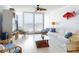 Bright living room featuring white furnishings and floor-to-ceiling windows with ocean views at 5201 S Atlantic Ave # 407A, New Smyrna Beach, FL 32169