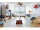 Bright living room featuring white furnishings and floor-to-ceiling windows with ocean views at 5201 S Atlantic Ave # 407A, New Smyrna Beach, FL 32169