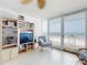 Bright living room featuring white furnishings and floor-to-ceiling windows with ocean views at 5201 S Atlantic Ave # 407A, New Smyrna Beach, FL 32169