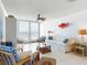 Bright living room featuring white furnishings and floor-to-ceiling windows with ocean views at 5201 S Atlantic Ave # 407A, New Smyrna Beach, FL 32169