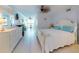 Comfortable main bedroom with tiled flooring, ceiling fan, dresser, and water view at 5201 S Atlantic Ave # 407A, New Smyrna Beach, FL 32169