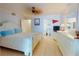 Comfortable main bedroom with tiled flooring, ceiling fan, dresser and ensuite bathroom at 5201 S Atlantic Ave # 407A, New Smyrna Beach, FL 32169