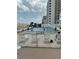 Community pool with lounge chairs and ocean view at 5201 S Atlantic Ave # 407A, New Smyrna Beach, FL 32169