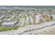 Wide aerial view of a beachfront condominium complex with ocean views, tennis courts, and community pool at 525 N Atlantic Ave # 39, New Smyrna Beach, FL 32169