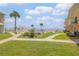 Beautifully maintained backyard with lush lawns, tropical palm trees, and partial ocean views at 525 N Atlantic Ave # 39, New Smyrna Beach, FL 32169