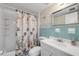 Cozy bathroom featuring a shower/tub combo and a sink with a nautical themed shower curtain at 525 N Atlantic Ave # 39, New Smyrna Beach, FL 32169