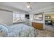 Bright bedroom featuring a queen-size bed and large window with outside views at 525 N Atlantic Ave # 39, New Smyrna Beach, FL 32169