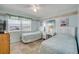 Bright bedroom with twin beds, beach-themed decor, tile flooring, and a window view at 525 N Atlantic Ave # 39, New Smyrna Beach, FL 32169