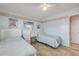 Sunlit bedroom with twin beds, complemented by soft colors, beachy artwork, and tile flooring at 525 N Atlantic Ave # 39, New Smyrna Beach, FL 32169
