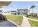 Charming condo building with a well-maintained lawn, sidewalk, and outdoor seating area at 525 N Atlantic Ave # 39, New Smyrna Beach, FL 32169