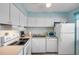 Efficient kitchen equipped with modern appliances, tile backsplash, and ample counter space for meal preparation at 525 N Atlantic Ave # 39, New Smyrna Beach, FL 32169