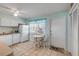 Cozy kitchen with white appliances and a quaint breakfast nook bathed in natural light at 525 N Atlantic Ave # 39, New Smyrna Beach, FL 32169