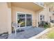 Private patio with sliding glass doors offering outdoor seating space and backyard access at 525 N Atlantic Ave # 39, New Smyrna Beach, FL 32169