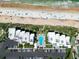Aerial view of beachfront condos with a pool and access to a sandy beach at 5301 S Atlantic Ave # 140, New Smyrna Beach, FL 32169