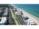 Stunning aerial view showcasing the oceanfront condos along the pristine beach and scenic coastal highway at 5301 S Atlantic Ave # 140, New Smyrna Beach, FL 32169