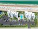An aerial view of a beachfront condo community with a pool, parking, and easy beach access at 5301 S Atlantic Ave # 140, New Smyrna Beach, FL 32169