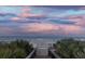 Walkway to the beach with lush foliage around the access point and ocean views at 5301 S Atlantic Ave # 140, New Smyrna Beach, FL 32169