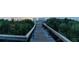 Private wooden walkway leading to a sandy beach is surrounded by tropical foliage at 5301 S Atlantic Ave # 140, New Smyrna Beach, FL 32169