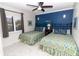 Cozy bedroom featuring twin beds, coastal decor, and ample natural light from the window at 5301 S Atlantic Ave # 140, New Smyrna Beach, FL 32169