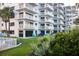 Building exterior featuring balconies and lush landscaping, and lawn with furniture at 5301 S Atlantic Ave # 140, New Smyrna Beach, FL 32169
