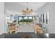 Dining room with rustic table, decorative lighting, and ocean view through sliding glass doors at 5301 S Atlantic Ave # 140, New Smyrna Beach, FL 32169