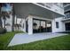 Exterior view with sliding glass doors leading to a well-manicured lawn with palm trees at 5301 S Atlantic Ave # 140, New Smyrna Beach, FL 32169