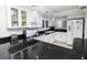 Modern kitchen with white cabinets, black countertops, and stainless steel appliances at 5301 S Atlantic Ave # 140, New Smyrna Beach, FL 32169