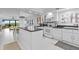 Bright kitchen with white cabinetry, black countertops and eat in dining room at 5301 S Atlantic Ave # 140, New Smyrna Beach, FL 32169