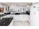 Bright kitchen featuring white cabinetry, granite countertops, and subway tile backsplash at 5301 S Atlantic Ave # 140, New Smyrna Beach, FL 32169