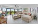 Bright living room with sliding glass doors leading to a patio with lawn views at 5301 S Atlantic Ave # 140, New Smyrna Beach, FL 32169