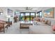 Spacious living room with sliding glass doors leading to a patio with ocean views at 5301 S Atlantic Ave # 140, New Smyrna Beach, FL 32169