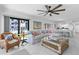 Bright living room with beachy decor, comfortable seating, and access to outdoor pool at 5301 S Atlantic Ave # 140, New Smyrna Beach, FL 32169