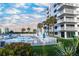Pool area with lounge chairs and palm trees near the building, offering a relaxing retreat at 5301 S Atlantic Ave # 140, New Smyrna Beach, FL 32169