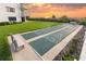 Outdoor shuffleboard courts with benches are set near a well-maintained green lawn at 5301 S Atlantic Ave # 140, New Smyrna Beach, FL 32169
