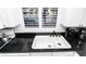 A close up view of the kitchen sink, countertop, and cabinets at 5301 S Atlantic Ave # 140, New Smyrna Beach, FL 32169