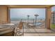 Relaxing condo balcony featuring seating with views of the beach, pools, and ocean at 5501 S Atlantic Ave # 4090, New Smyrna Beach, FL 32169