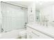 Bathroom featuring a subway tile shower with glass doors, brushed silver hardware, and ample lighting at 5501 S Atlantic Ave # 4090, New Smyrna Beach, FL 32169