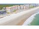 Oceanfront condos sit next to a beautiful beach with soft waves crashing on the shore at 5501 S Atlantic Ave # 4090, New Smyrna Beach, FL 32169