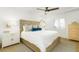 Bright bedroom with light wood flooring, textured headboard, and a large comfortable bed at 5501 S Atlantic Ave # 4090, New Smyrna Beach, FL 32169