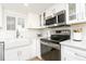 Bright renovated kitchen featuring white cabinets, stainless appliances, and quartz countertops at 5501 S Atlantic Ave # 4090, New Smyrna Beach, FL 32169