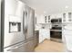 Bright renovated kitchen featuring stainless steel refrigerator, quartz countertops, and white cabinetry at 5501 S Atlantic Ave # 4090, New Smyrna Beach, FL 32169